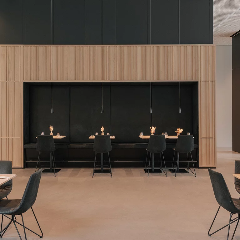 Elegant restaurant seating with lui bar stools and solid wood tables in natural oak oil