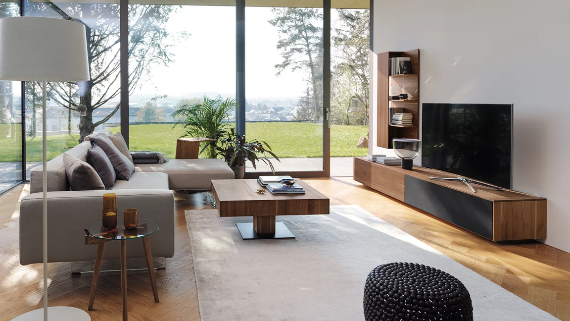 elegant living room with filigno wall unit, hi! side table and lift coffee table in walnut and basalt black ceramic