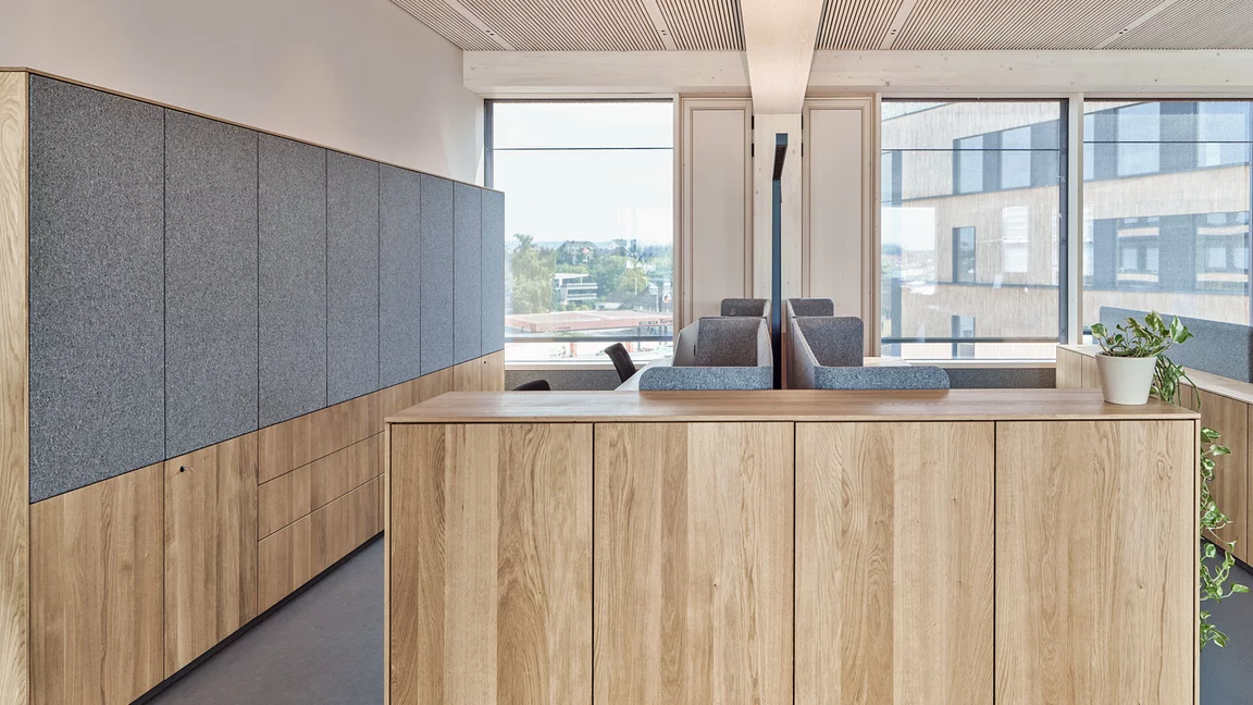 Customised storage units with filigno highboards and sideboards in natural oak oil, some with textile upholstery