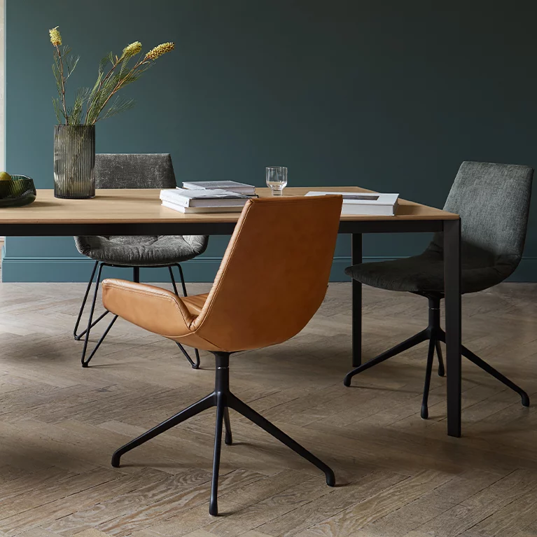 modern extendable dining table tak made of solid wood with frame in matt black and the lui chair family