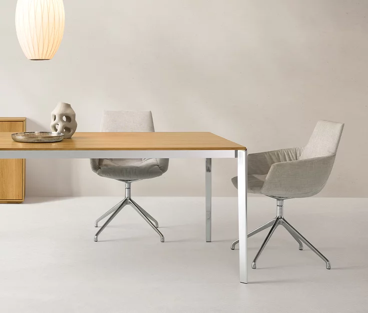 Elegant lui leger dining chairs with Maple 112 textile upholstery on a shiny stainless steel swivel base at tak solid oak table