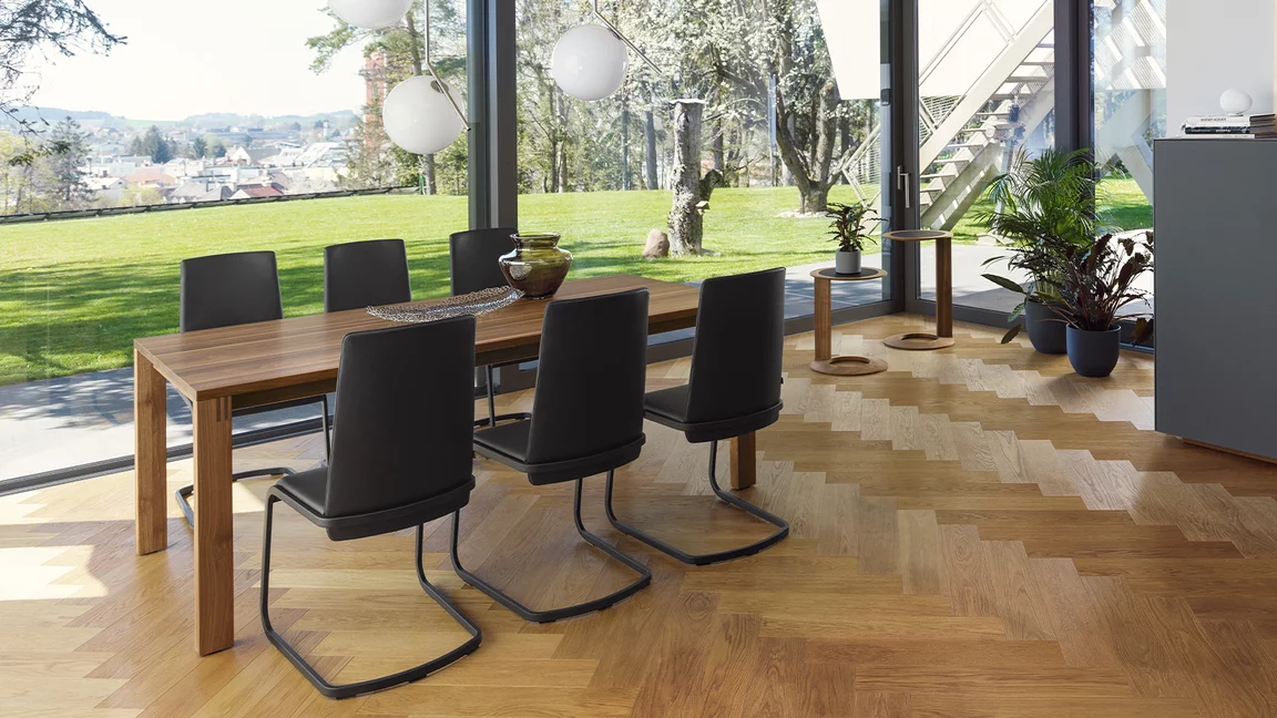 comfortable f1 cantilever chair upholstered with frame in matt black and magnum dining table in walnut