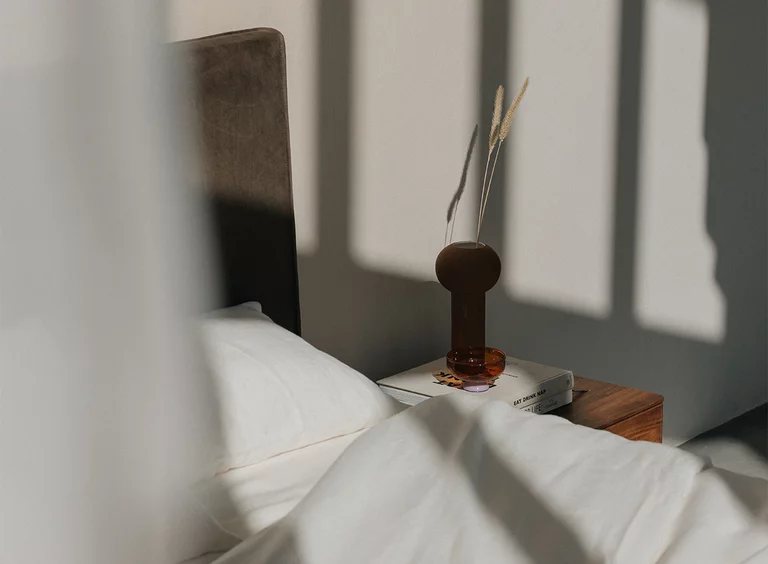wooden bed float in solid walnut with leather headboard, bed accessories and the float bedside cabinet, detail